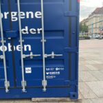 Blauer Überseecontainer mit weißen Logos